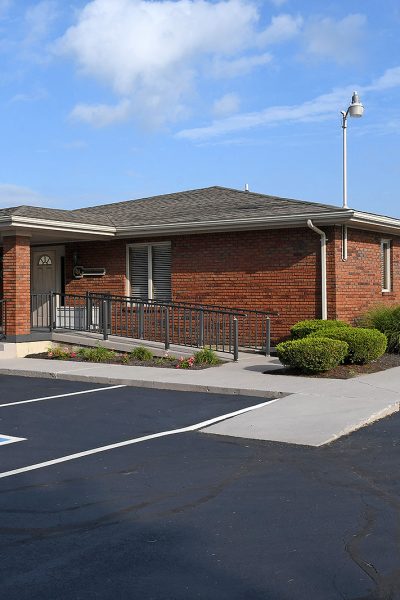 Single-story brick building with accessible parking